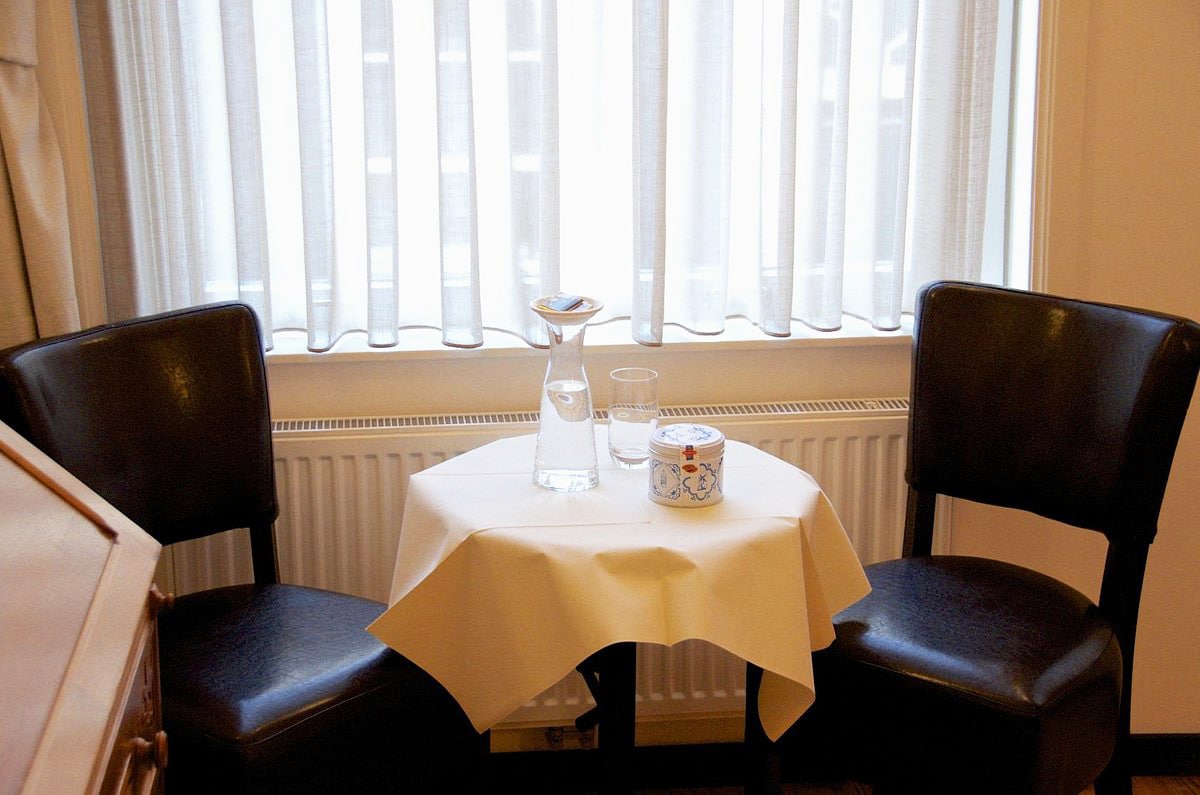 image of a small table with chairs in front of the window of our South Room (Bed & Breakfast)